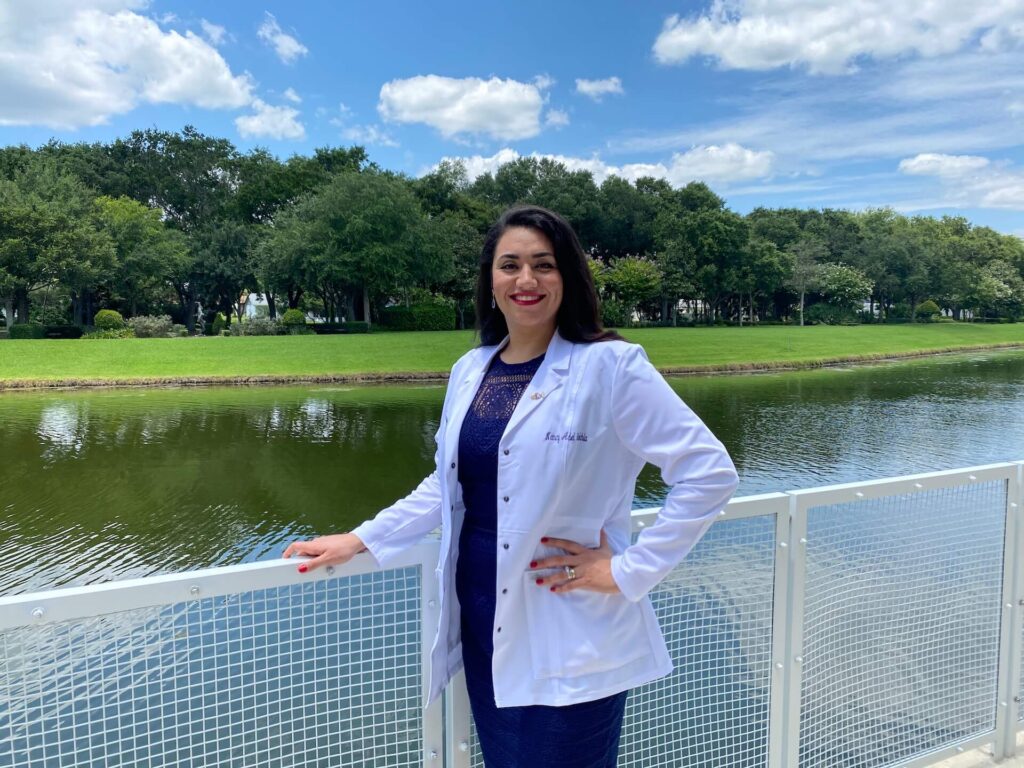 Dr. Nathan, a chiropractor in New Smyrna Beach, FL posing in front of a lake
